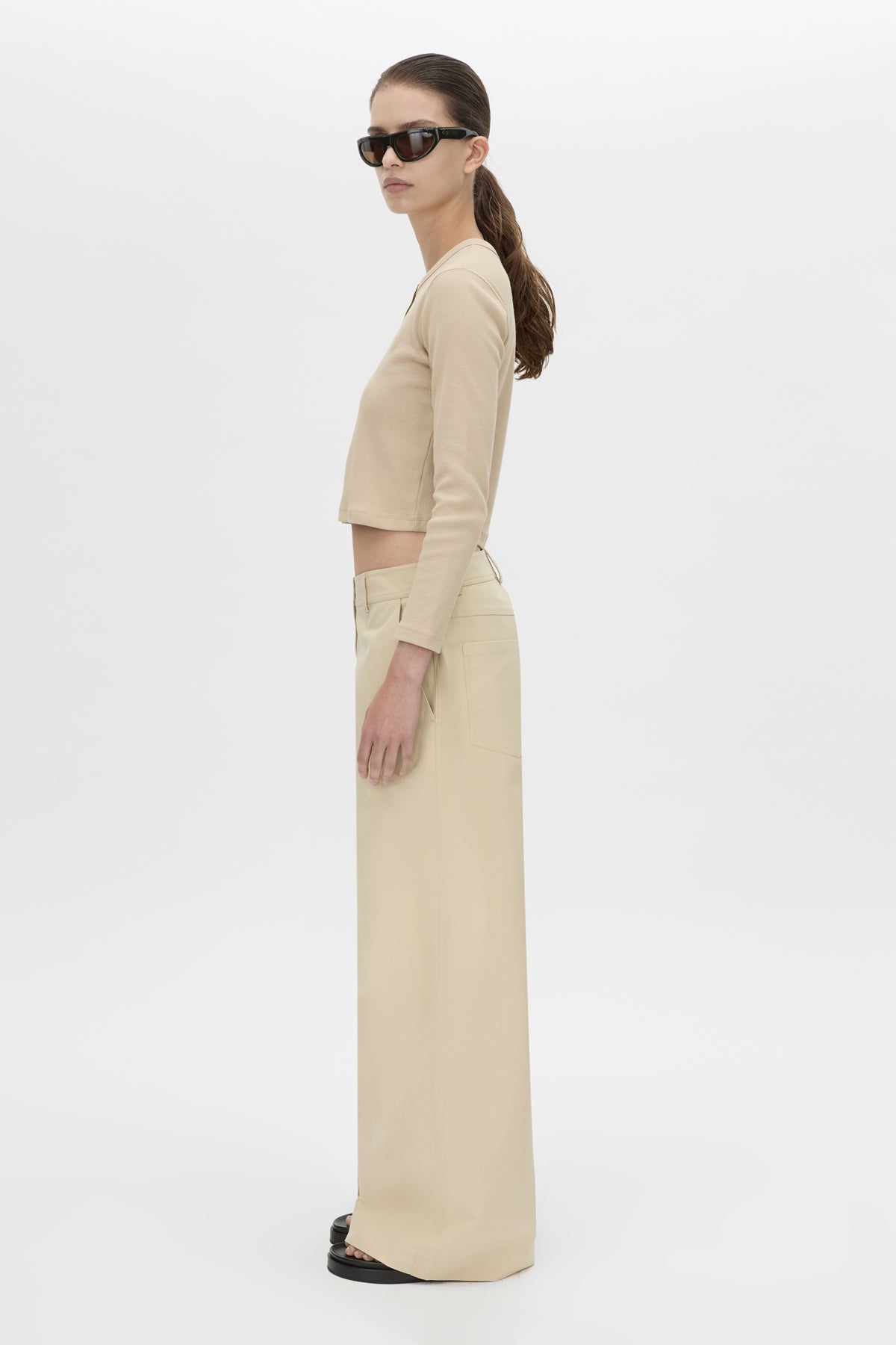 Side view CAMILLA AND MARC Aubrey Long Sleeve Rib Top in Latte with a contrast corozo button placket.