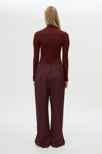 Back view CAMILLA AND MARC Barre High Neck Top in Burgundy with long sleeves and V‑neck split turtleneck.
