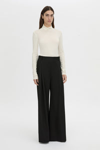 Front-styled-2 view CAMILLA AND MARC Barre turtleneck long-sleeve top in soft white.
