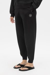 Cropped view CAMILLA AND MARC Bonnie relaxed logo track pant in black with elasticated drawcord waistband.