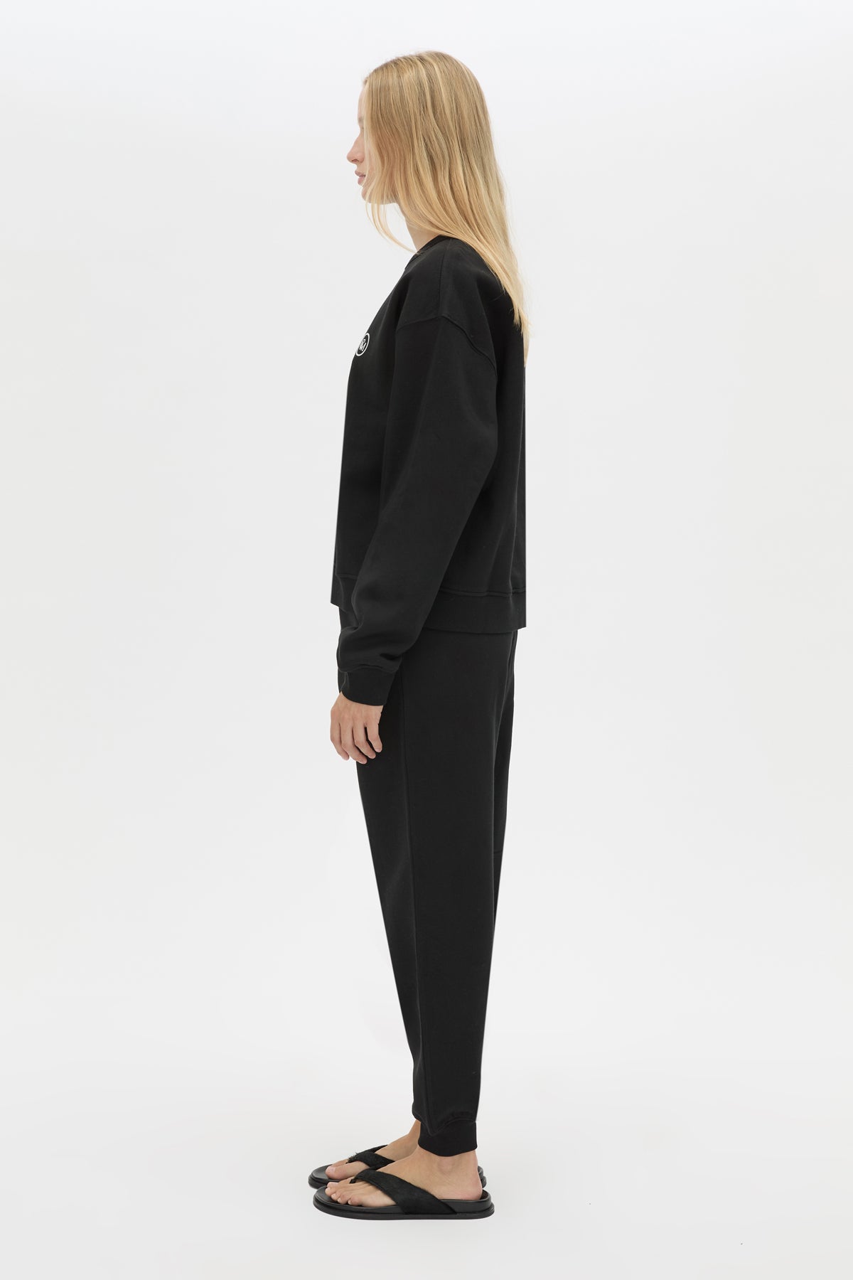 Side view CAMILLA AND MARC Bonnie relaxed logo track pant in black with elasticated drawcord waistband.