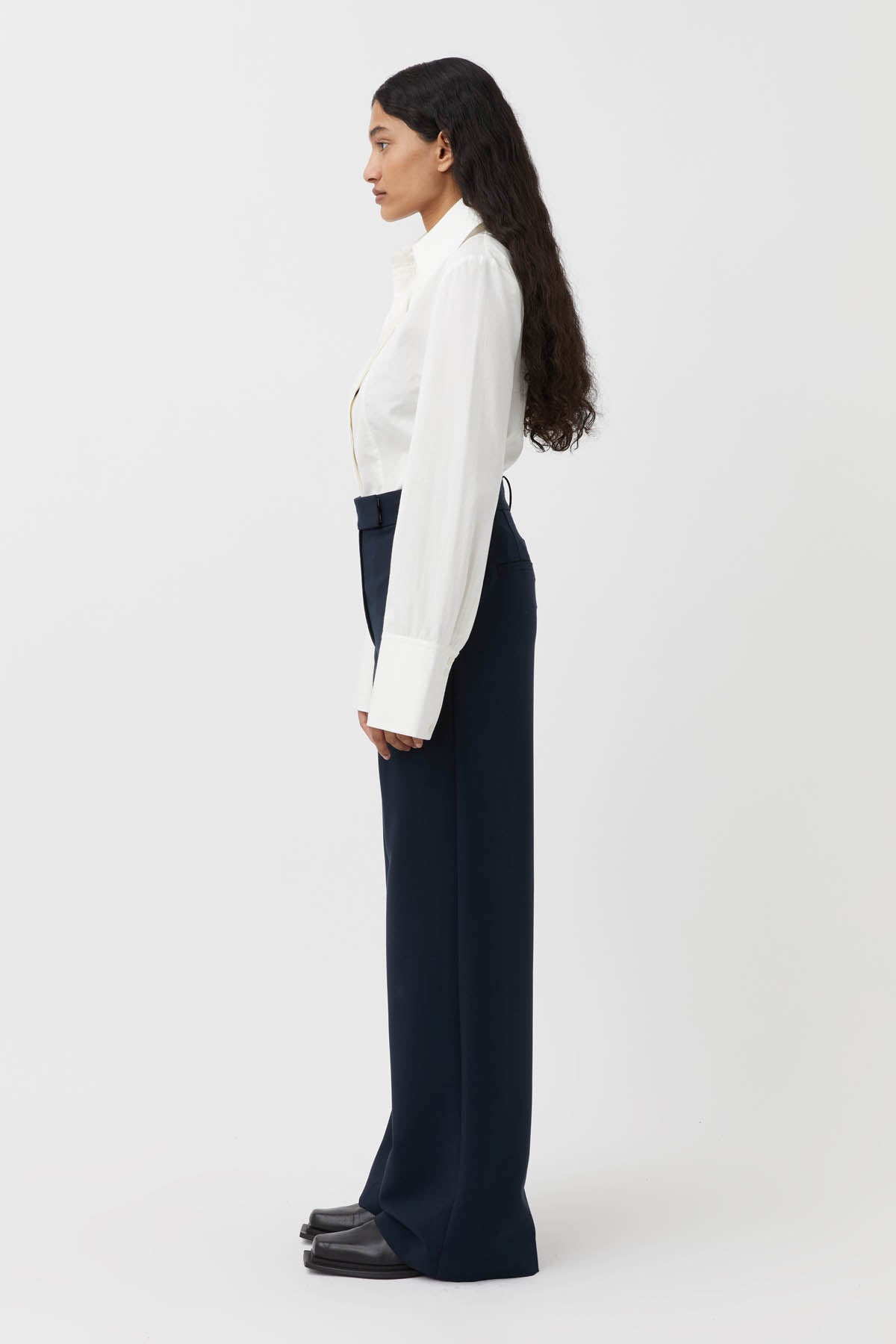 CAMILLA AND MARC Bostan High-waisted Tailored Pant in Navy Blue.

Crafted from a premium blend of materials, this versatile piece is designed to elevate the everyday wardrobe. With a high-rise waistline and a sleek, slim-fitting silhouette, these pants are the perfect blend of style and comfort. The sharp, tailored finish through the pressed pleats exudes sophistication, while the high-waisted design elongates the legs for a flattering fit.