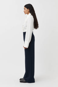 CAMILLA AND MARC Bostan High-waisted Tailored Pant in Navy Blue.

Crafted from a premium blend of materials, this versatile piece is designed to elevate the everyday wardrobe. With a high-rise waistline and a sleek, slim-fitting silhouette, these pants are the perfect blend of style and comfort. The sharp, tailored finish through the pressed pleats exudes sophistication, while the high-waisted design elongates the legs for a flattering fit.