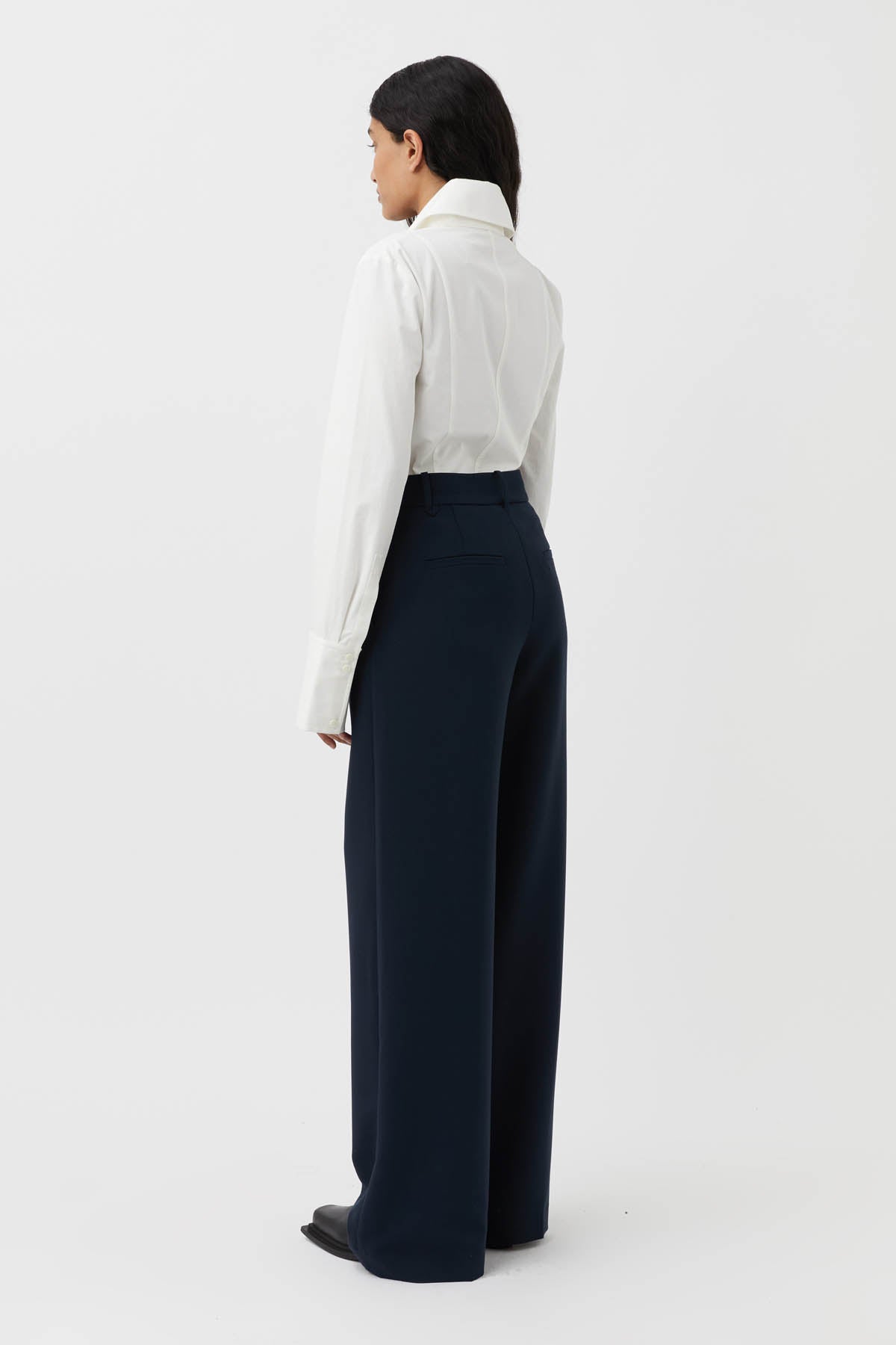 CAMILLA AND MARC Bostan High-waisted Tailored Pant in Navy Blue.

Crafted from a premium blend of materials, this versatile piece is designed to elevate the everyday wardrobe. With a high-rise waistline and a sleek, slim-fitting silhouette, these pants are the perfect blend of style and comfort. The sharp, tailored finish through the pressed pleats exudes sophistication, while the high-waisted design elongates the legs for a flattering fit.