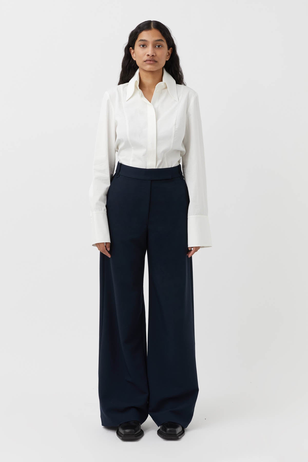 CAMILLA AND MARC Bostan High-waisted Tailored Pant in Navy Blue.

Crafted from a premium blend of materials, this versatile piece is designed to elevate the everyday wardrobe. With a high-rise waistline and a sleek, slim-fitting silhouette, these pants are the perfect blend of style and comfort. The sharp, tailored finish through the pressed pleats exudes sophistication, while the high-waisted design elongates the legs for a flattering fit.