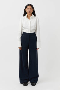 CAMILLA AND MARC Bostan High-waisted Tailored Pant in Navy Blue.

Crafted from a premium blend of materials, this versatile piece is designed to elevate the everyday wardrobe. With a high-rise waistline and a sleek, slim-fitting silhouette, these pants are the perfect blend of style and comfort. The sharp, tailored finish through the pressed pleats exudes sophistication, while the high-waisted design elongates the legs for a flattering fit.