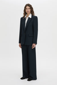 Front-styled-2 view CAMILLA AND MARC Bostan Blazer in a tailored navy fabrication, single-breasted silhouette, sharp shoulder pads, flap welt pockets, chest mock welt pocket, centre back vent and fully lined.