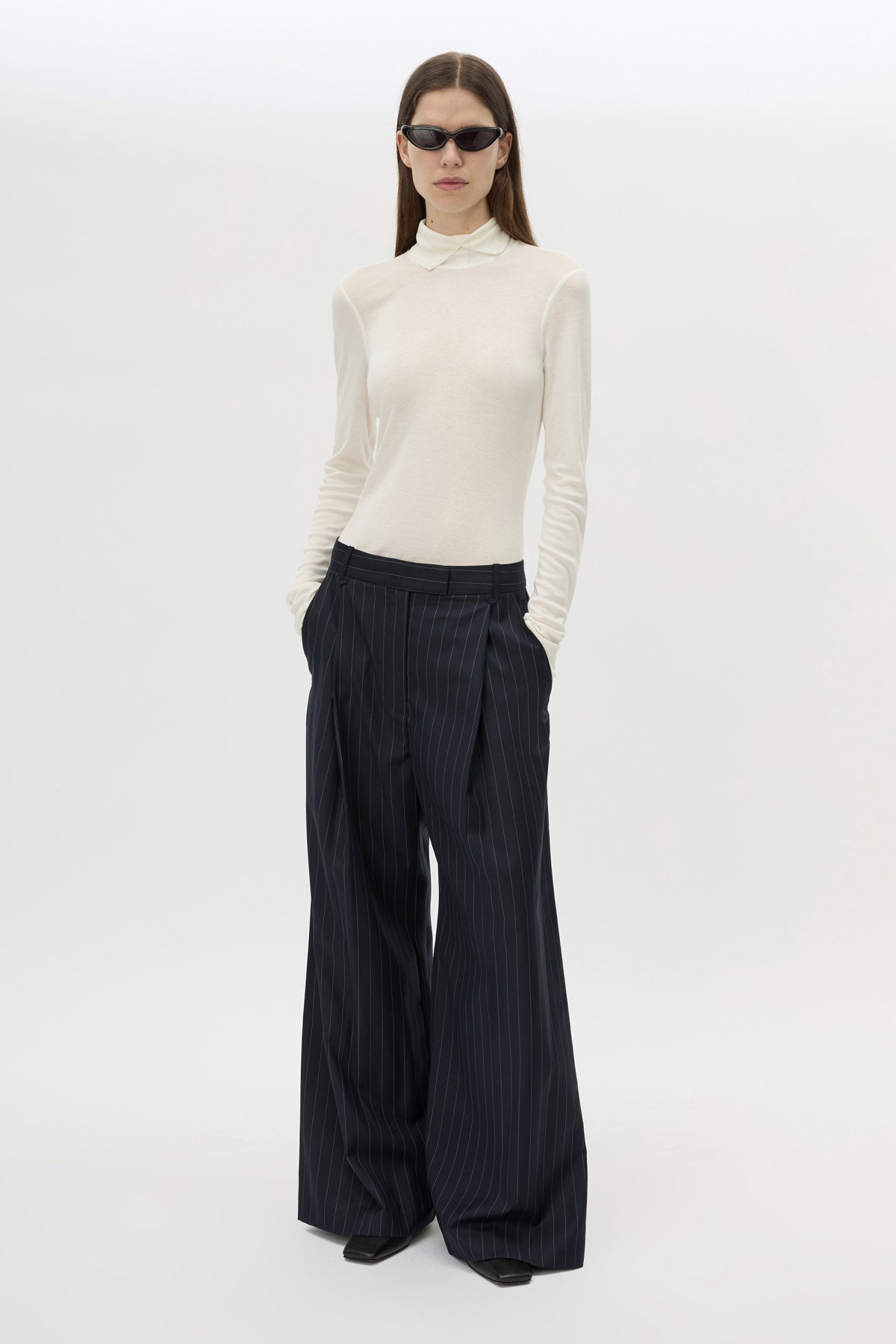 Front View - CAMILLA AND MARC Barre turtleneck long sleeve top in soft white. V-neck detail at neckline. 