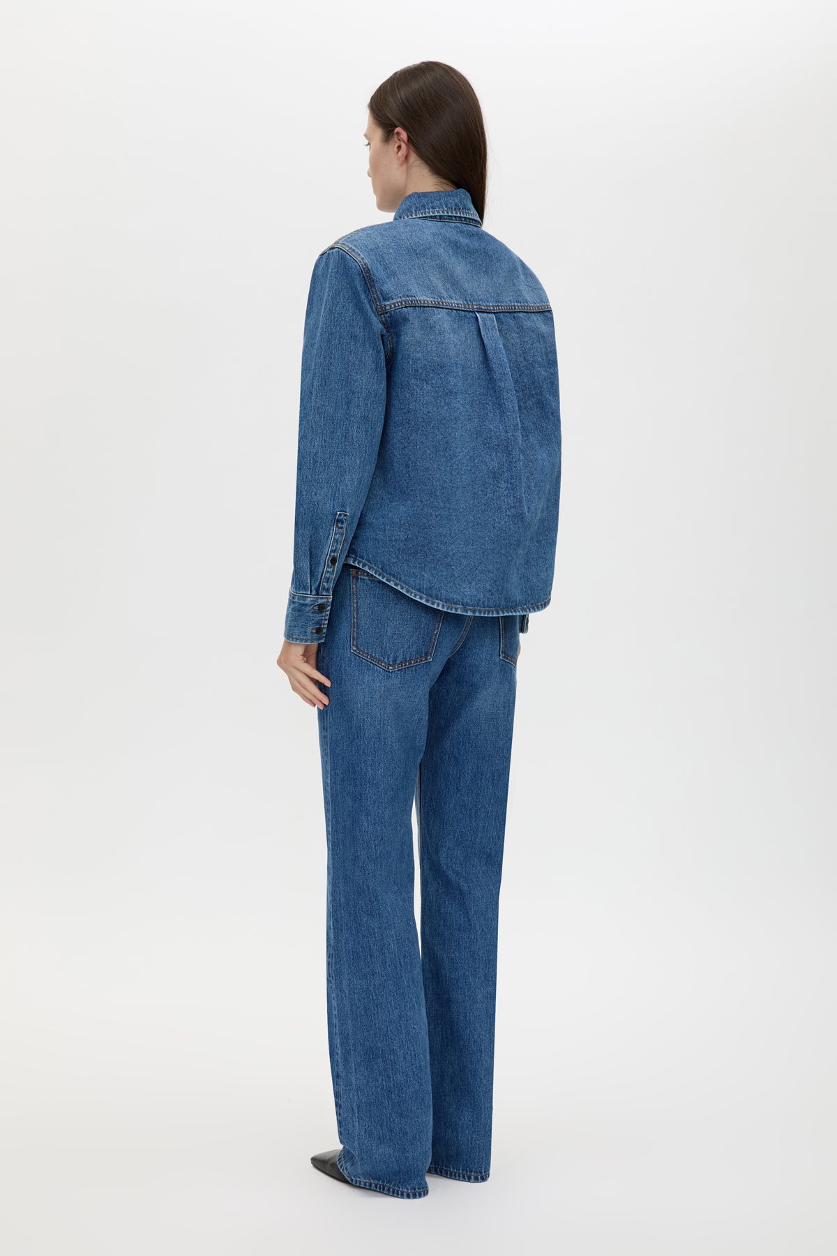 Back view CAMILLA AND MARC Caden Denim Shirt in Dark Classic Blue with shoulder pads and an embroidered monogram.