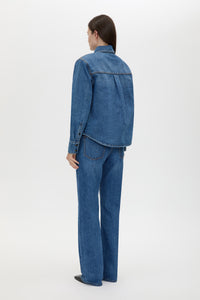 Back view CAMILLA AND MARC Caden Denim Shirt in Dark Classic Blue with shoulder pads and an embroidered monogram.