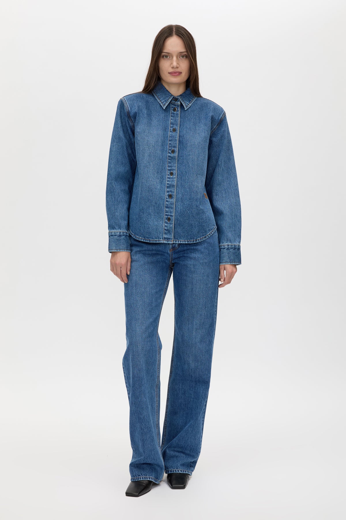 Front styled view CAMILLA AND MARC Caden Denim Shirt in Dark Classic Blue with shoulder pads and an embroidered monogram.