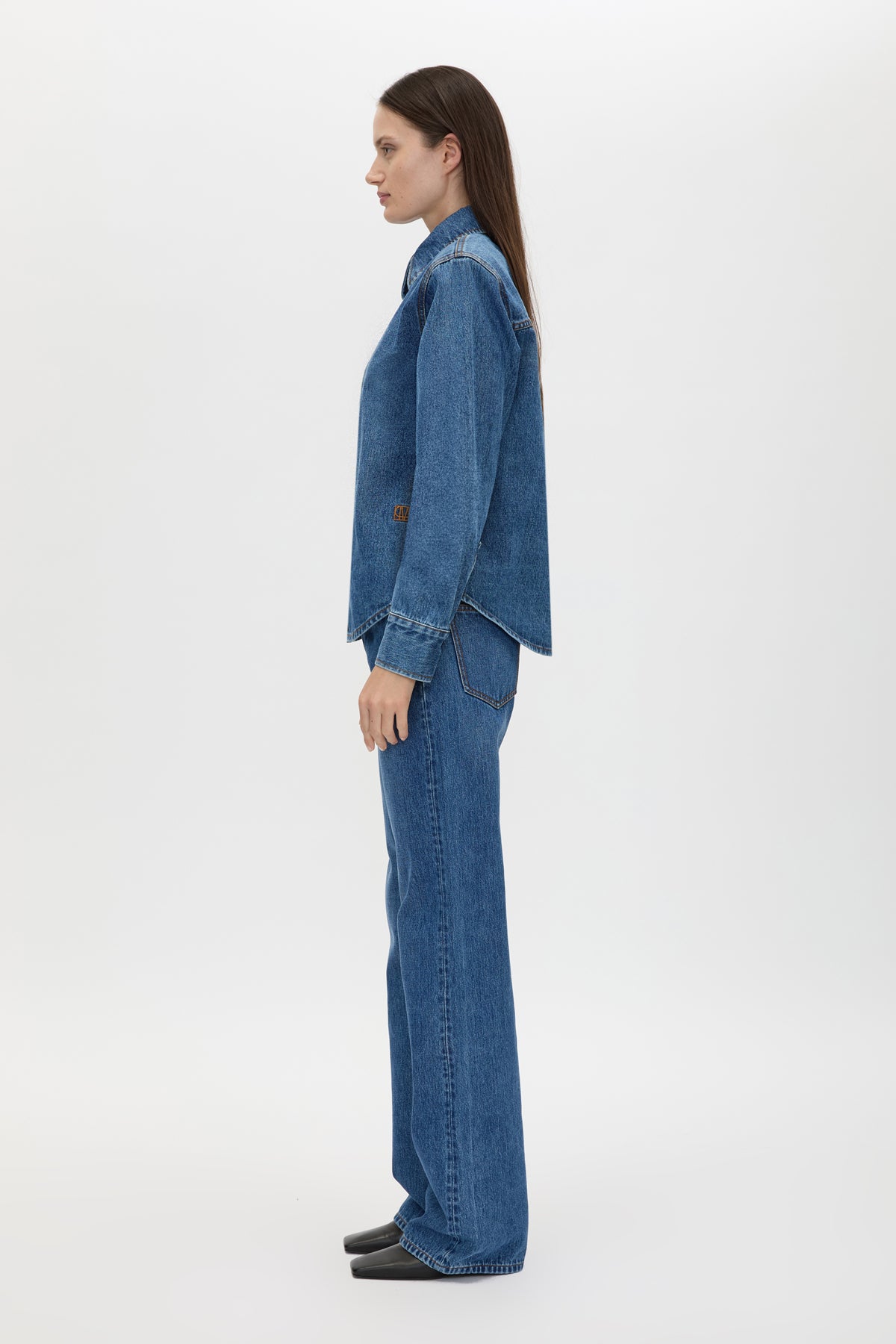 Side view CAMILLA AND MARC Caden Denim Shirt in Dark Classic Blue with shoulder pads and an embroidered monogram.