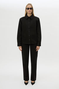 Front styled view CAMILLA AND MARC Caden Denim Shirt in True Black with shoulder pads and embroidered monogram detailing.