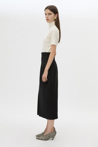 Side view CAMILLA AND MARC Caius High Corset Waist Midi Skirt in Black with structured waist.