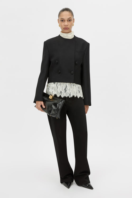 Front-styled view CAMILLA AND MARC double-breasted Caius Relaxed Cropped Blazer in black with a collarless neckline.