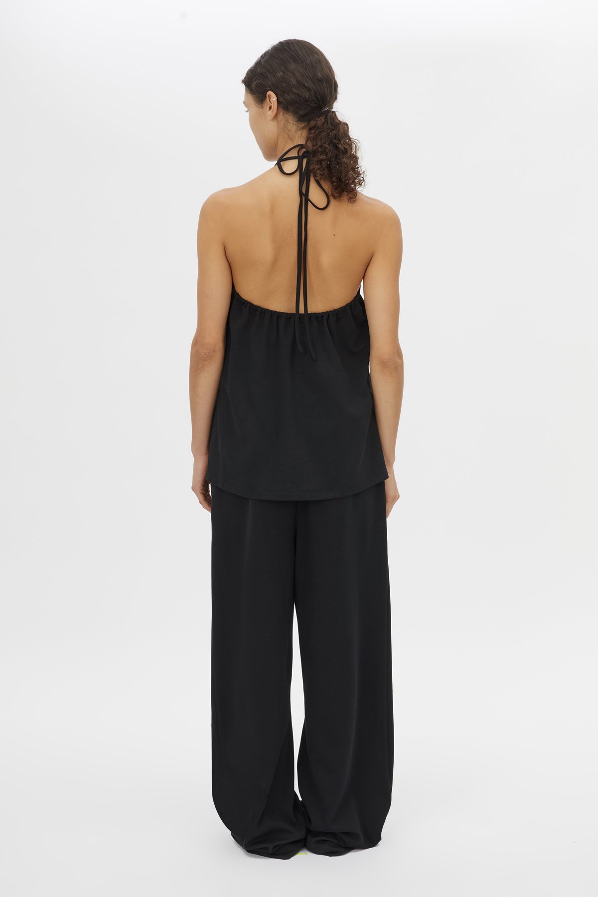 Back view CAMILLA AND MARC Canova Relaxed Pant in Black jersey with gathered waistband and drawcord.