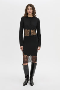 Front-styled view CAMILLA AND MARC Cayana Lace Knit Skirt in black with knit knee length design and lace hem detail.