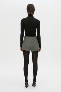 Back view CAMILLA AND MARC high waisted Cinder Mini Short in charcoal grey with invisible side seam closure.