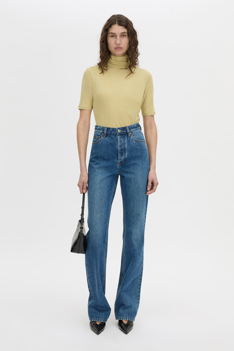 Front-styled view CAMILLA AND MARC Dakota slim fit lemongrass top with ribbed turtle neck.