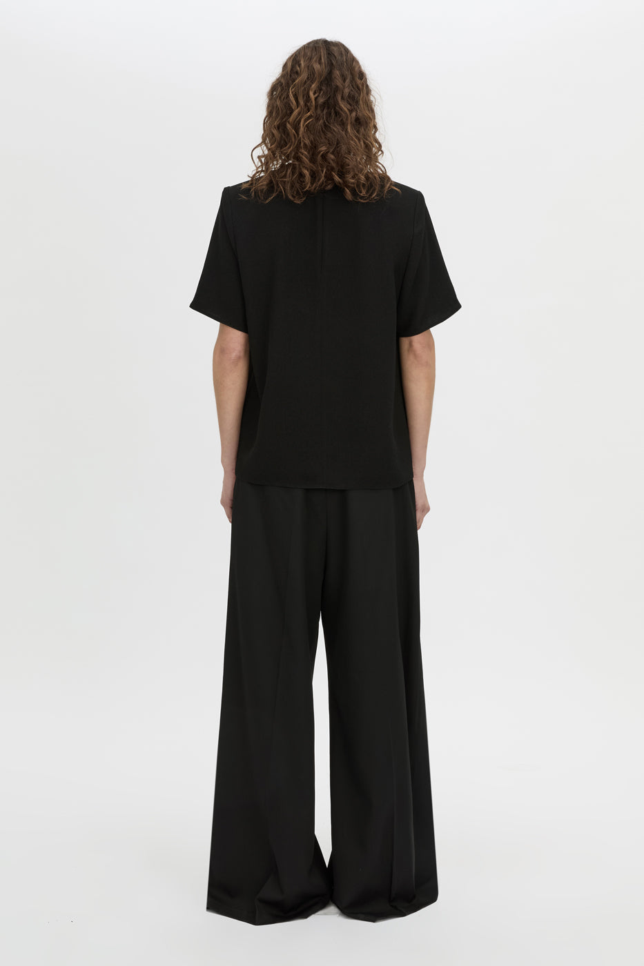 Back view CAMILLA AND MARC Darien short sleeve top in black.