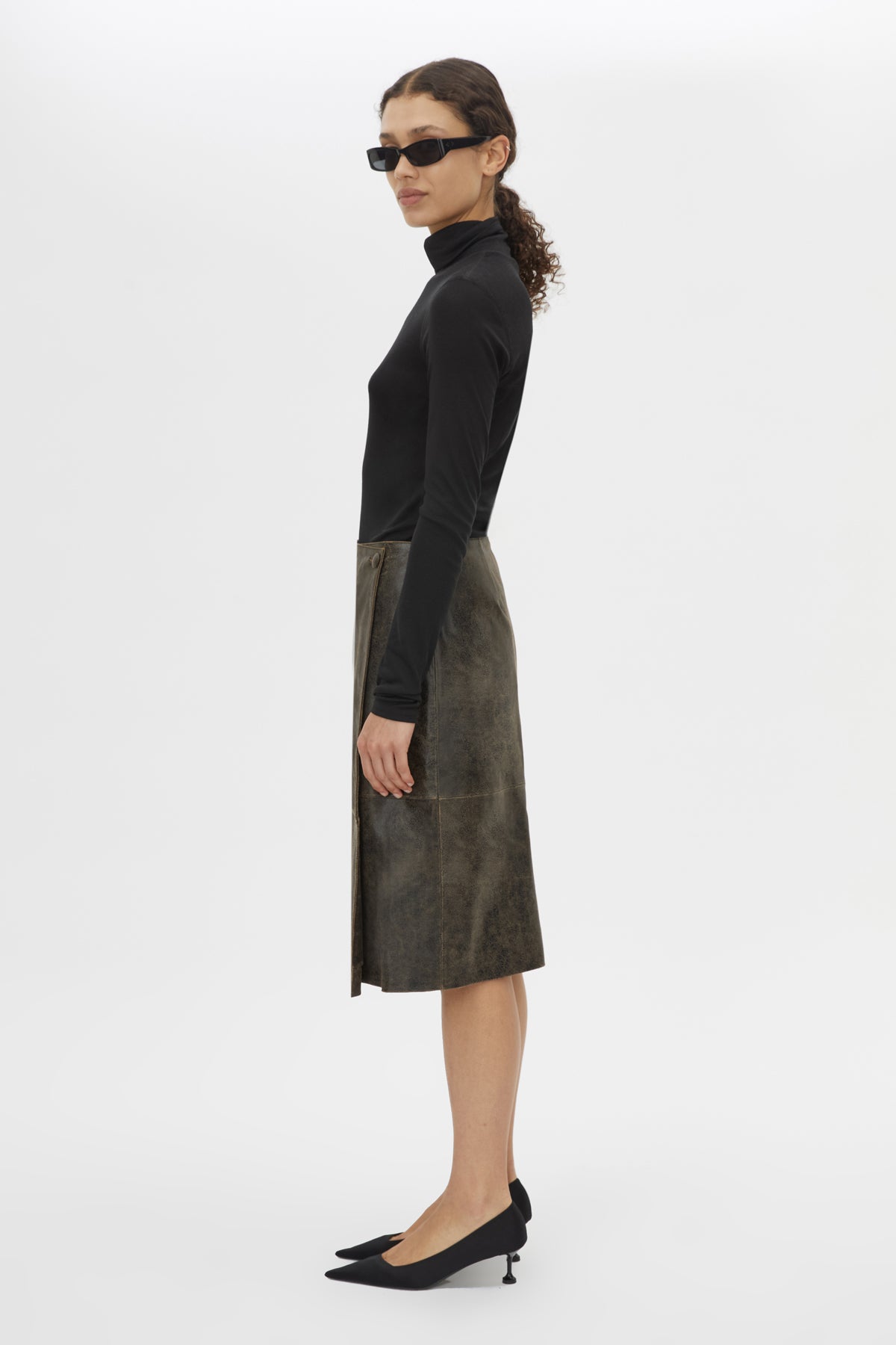 Side view CAMILLA AND MARC Dawn Leather Skirt in Black Brown with a wrap midi silhouette.