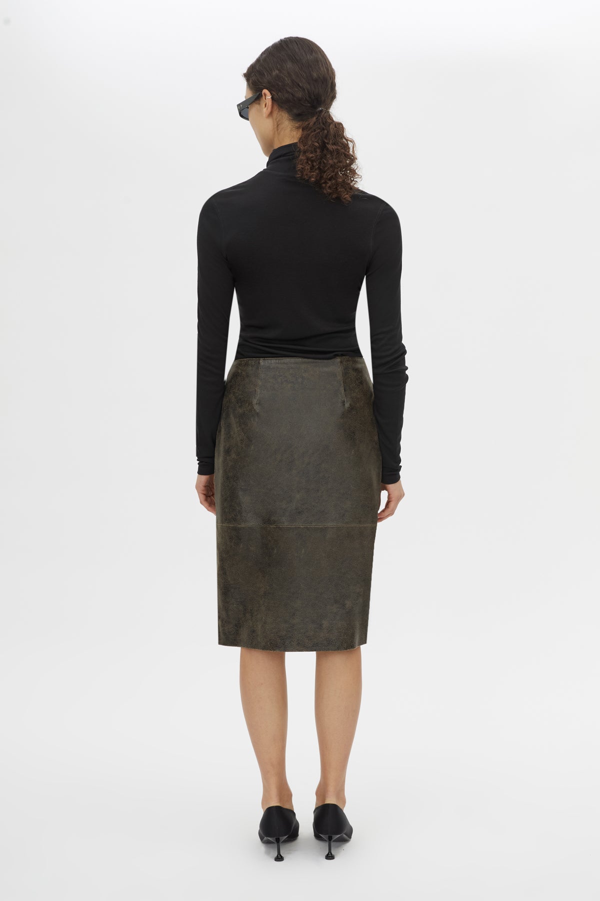 Back view CAMILLA AND MARC Dawn Leather Skirt in Black Brown with a wrap midi silhouette.