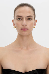 Front view CAMILLA AND MARC Eagan Earrings in gold with round semi‑sphere design and ruched texture.