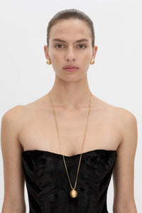 Front view CAMILLA AND MARC Eagan Pendant in gold with fine box chain and ruched textured sphere pendant.