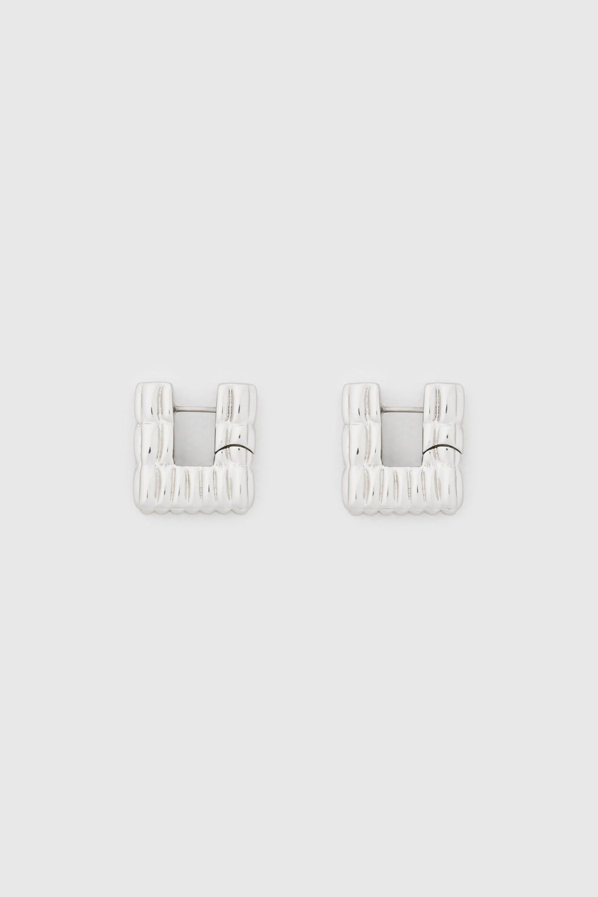Ghost view CAMILLA AND MARC Eagan Huggies in silver with square huggie design and ruched texture.