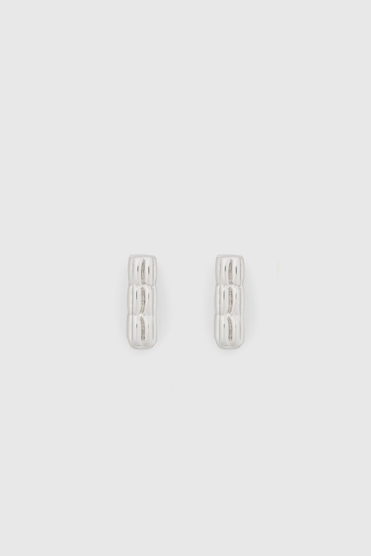 Ghost view CAMILLA AND MARC Eagan Huggies in silver with square huggie design and ruched texture.