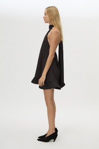 Side view CAMILLA AND MARC Elsen Halter Mini Dress in Black with open back, tie‑up neck and fluted crinoline hem.