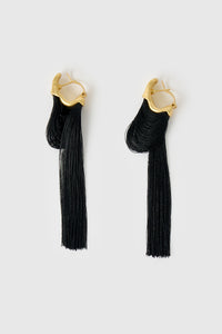 Side ghost view CAMILLA AND MARC Friesian Drop Earrings with 18k gold plating, featuring draped black tassel drop fringing.
