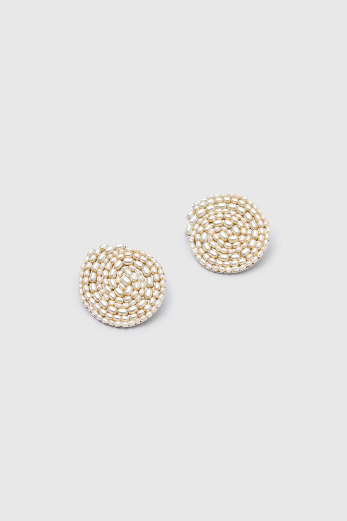 Ghost view CAMILLA AND MARC Irida Earrings in cream with spiral pearl design.