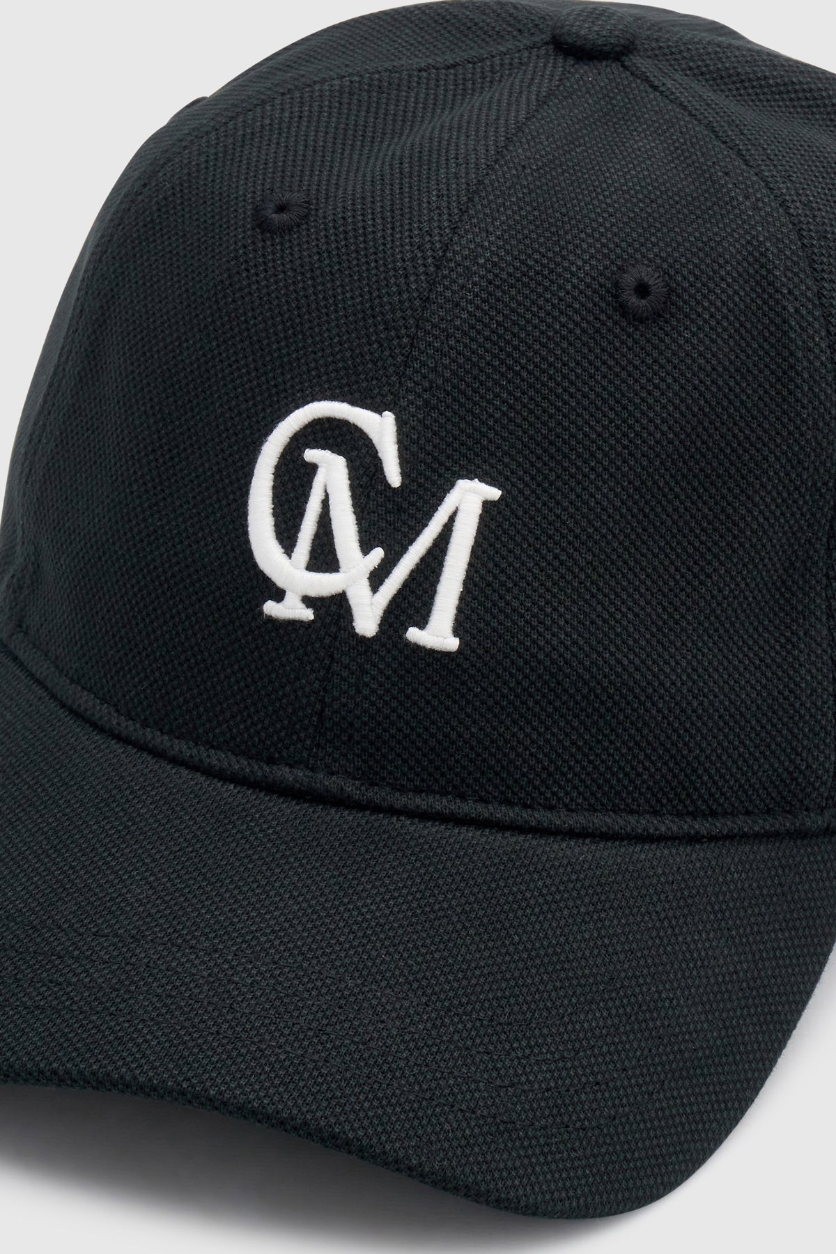 Cropped view CAMILLA AND MARC Isolde Embroidered Logo Cap in Black and White with front embroidered artwork.