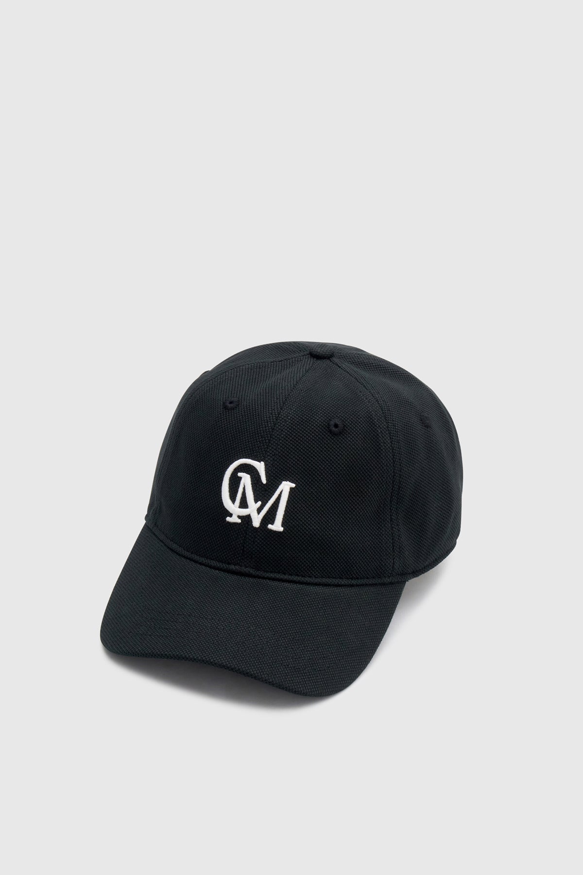Front view CAMILLA AND MARC Isolde Embroidered Logo Cap in Black and White with front embroidered artwork.