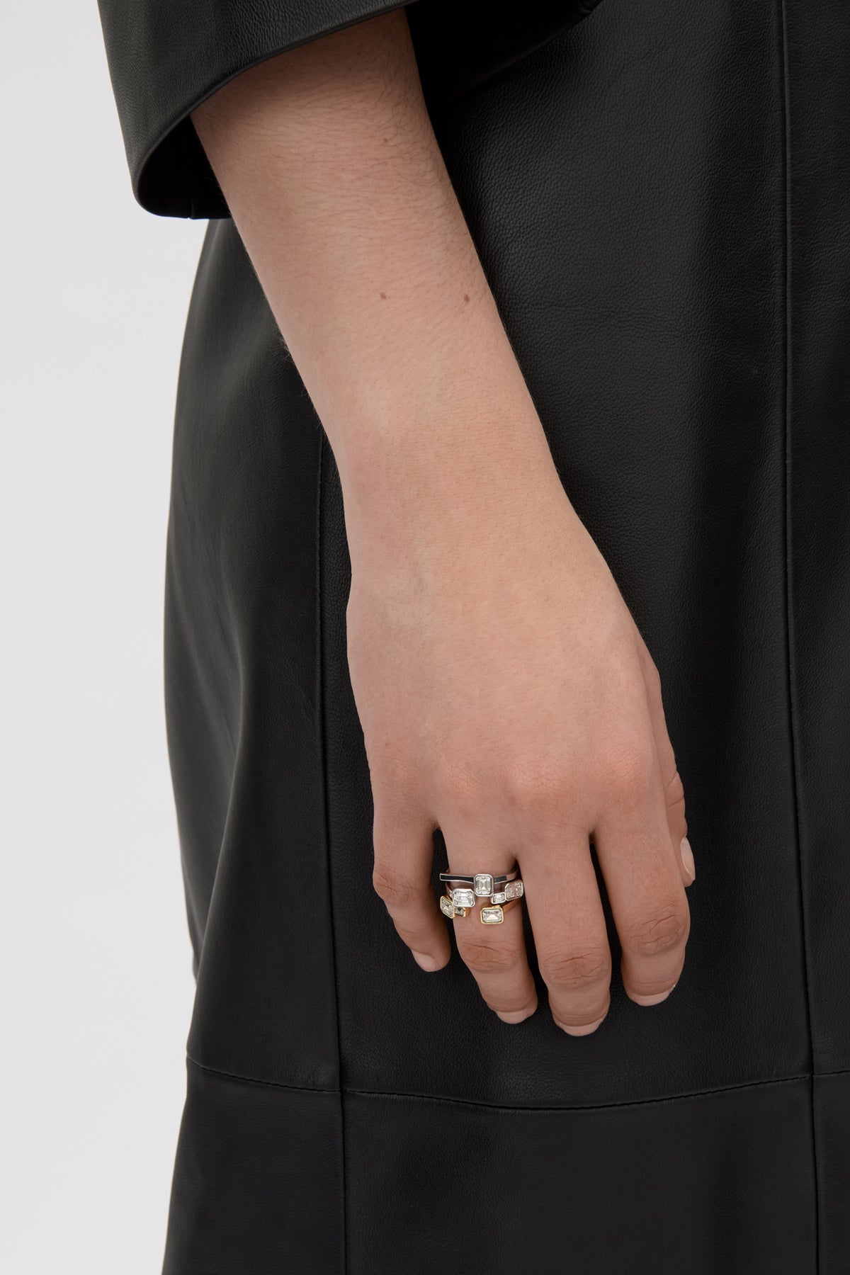 Front-styled view CAMILLA AND MARC Leighton Open Ring in 18k gold plating with emerald cut cubic zirconia stones.