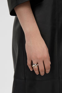 Front-styled view CAMILLA AND MARC Leighton Open Ring in silver with emerald cut cubic zirconia stones.