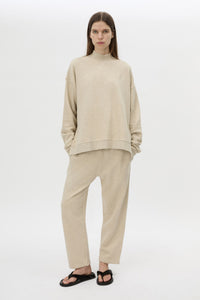 Front styled view CAMILLA AND MARC Lloyd Cropped Track Pant in cream with a straight leg and elasticated waist.
