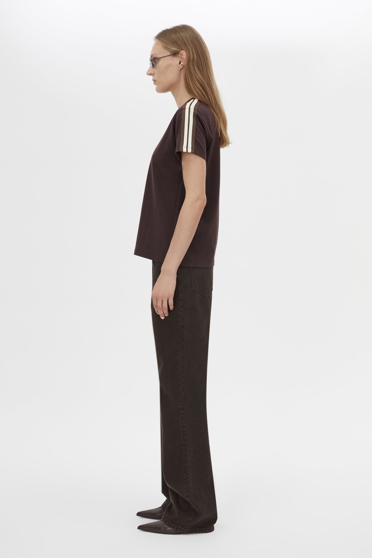 Side view CAMILLA AND MARC Locus Tee in Espresso with fitted baby‑tee silhouette and contrast stripe tape.  