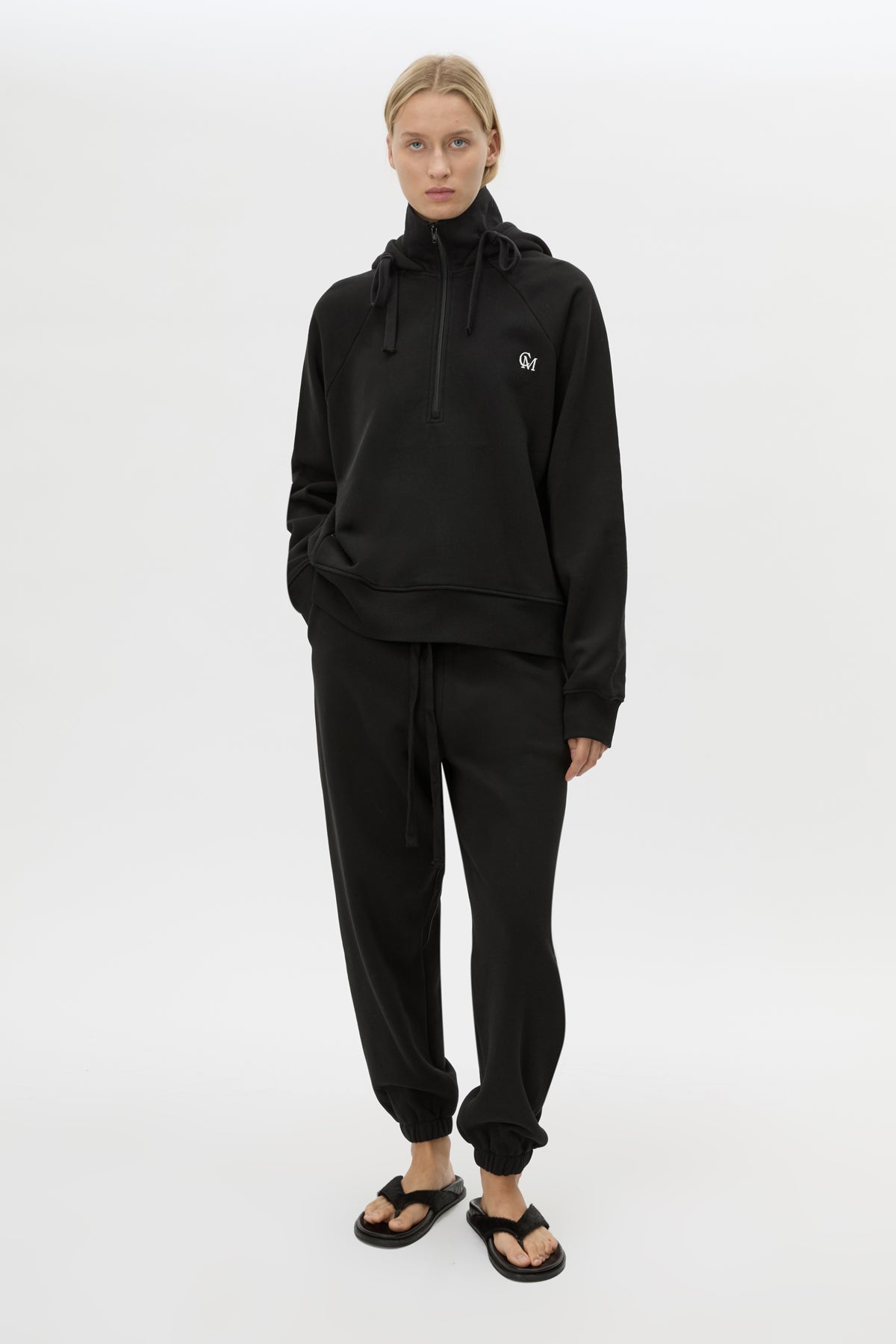 Front view CAMILLA AND MARC Lyra Embroidered Hoodie in Black and White with exposed quarter‑zip opening.