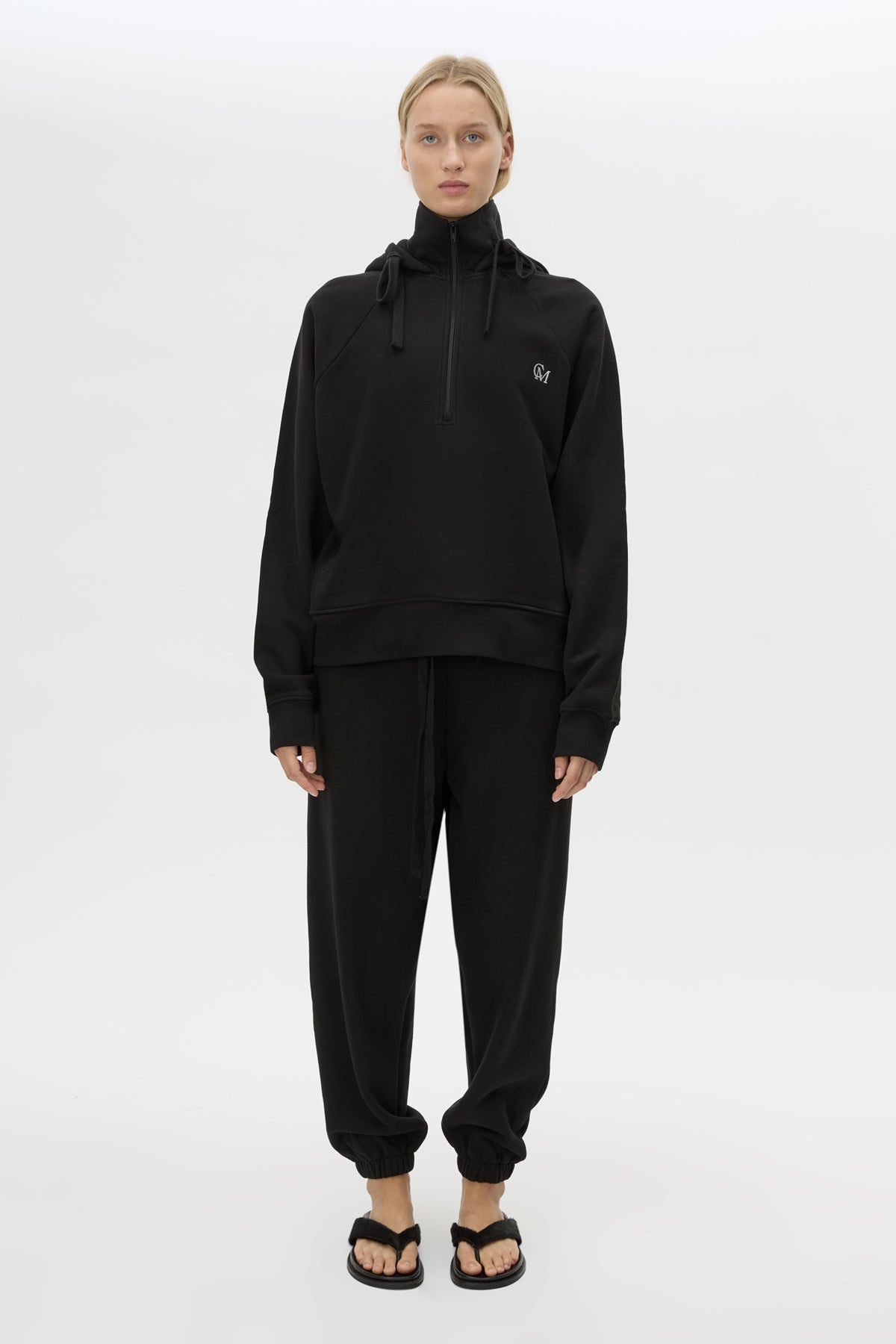 Front styled view CAMILLA AND MARC Lyra Embroidered Hoodie in Black and White with exposed quarter‑zip opening.