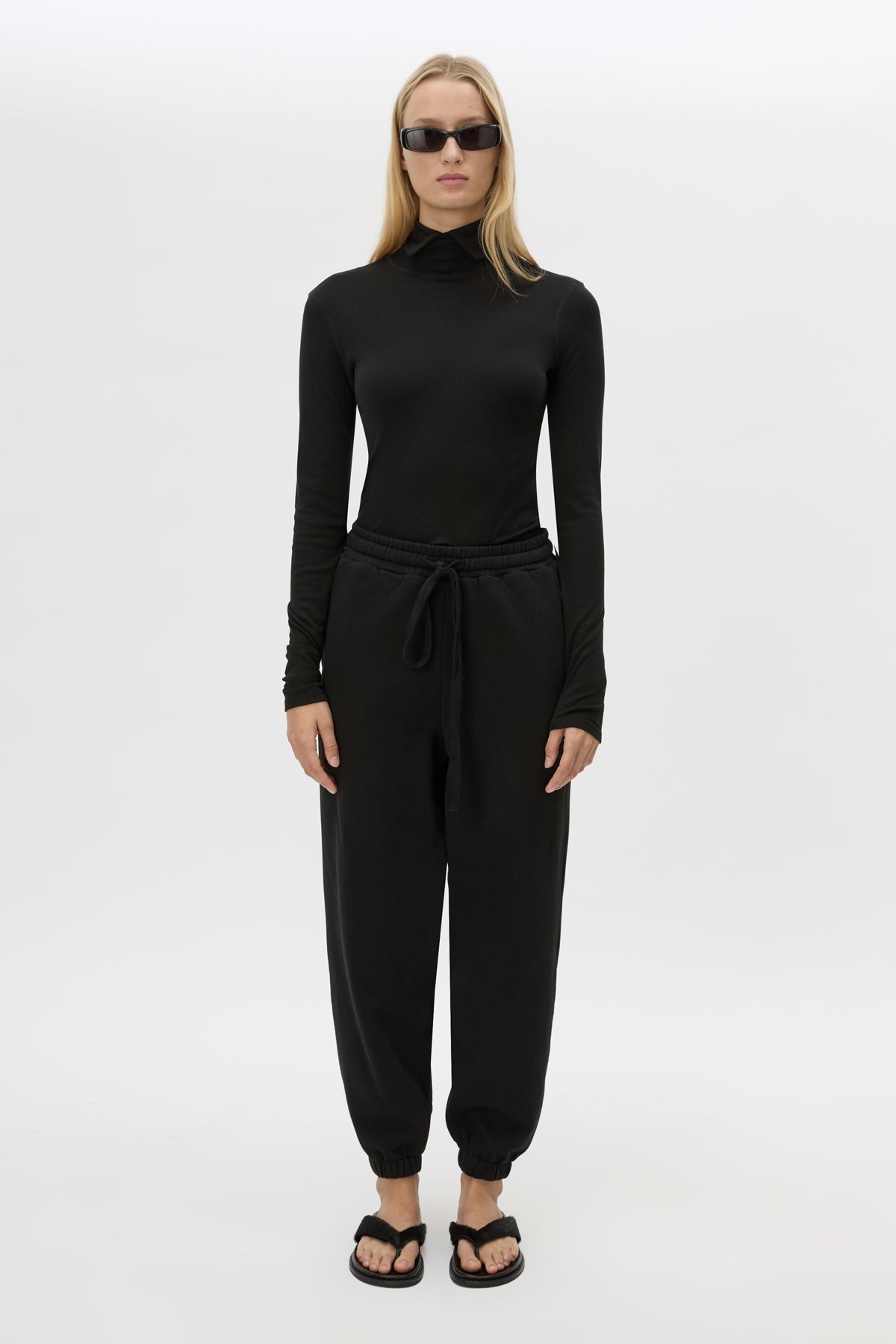 Front styled view CAMILLA AND MARC Lyra Logo Track Pant in Black and White with relaxed fit and embroidered initial detail.