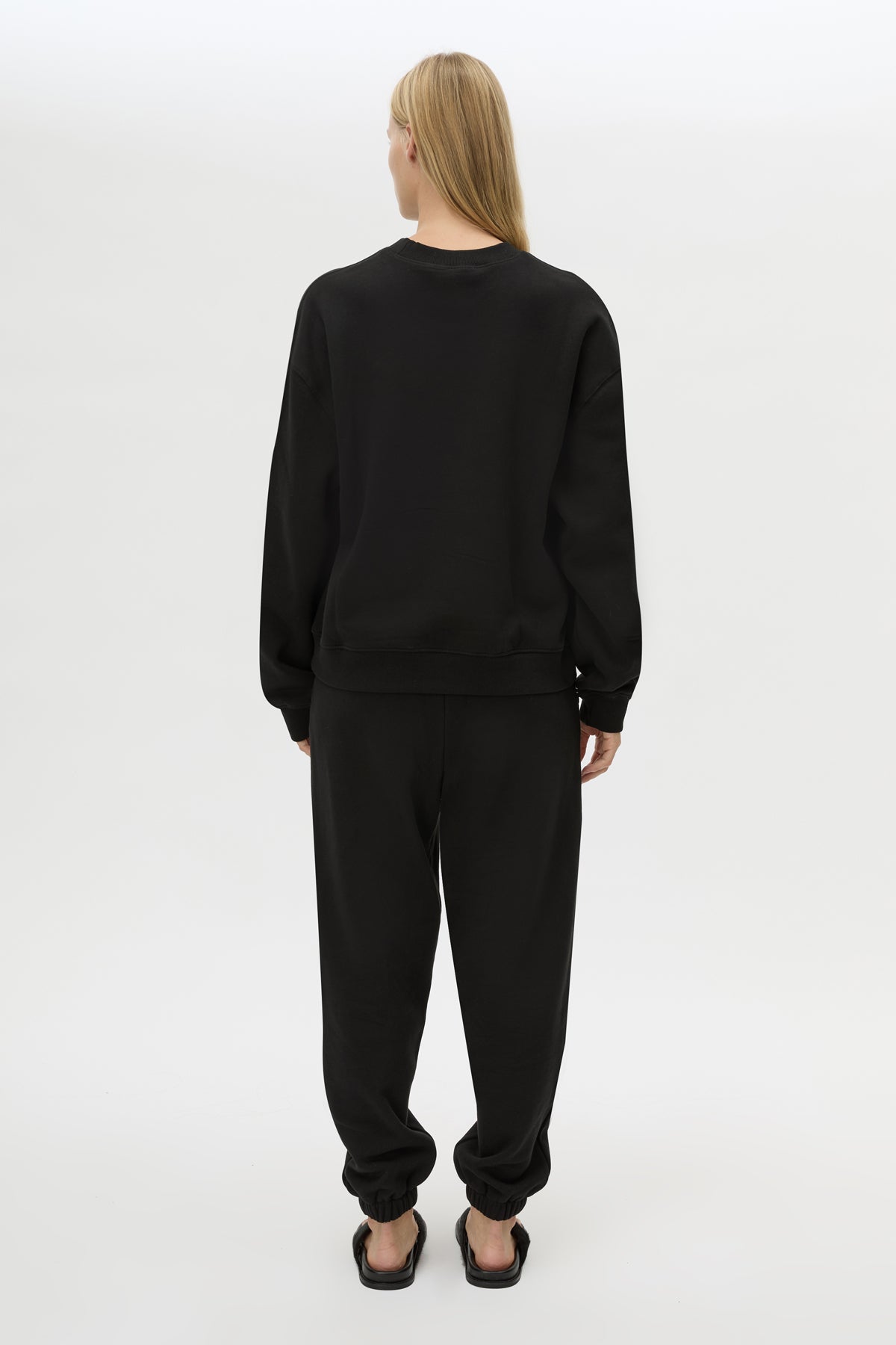 Back view CAMILLA AND MARC Lyra Logo Track Pant in Black and White with relaxed fit and embroidered initial detail.