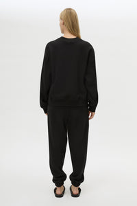Back view CAMILLA AND MARC Lyra Logo Track Pant in Black and White with relaxed fit and embroidered initial detail.