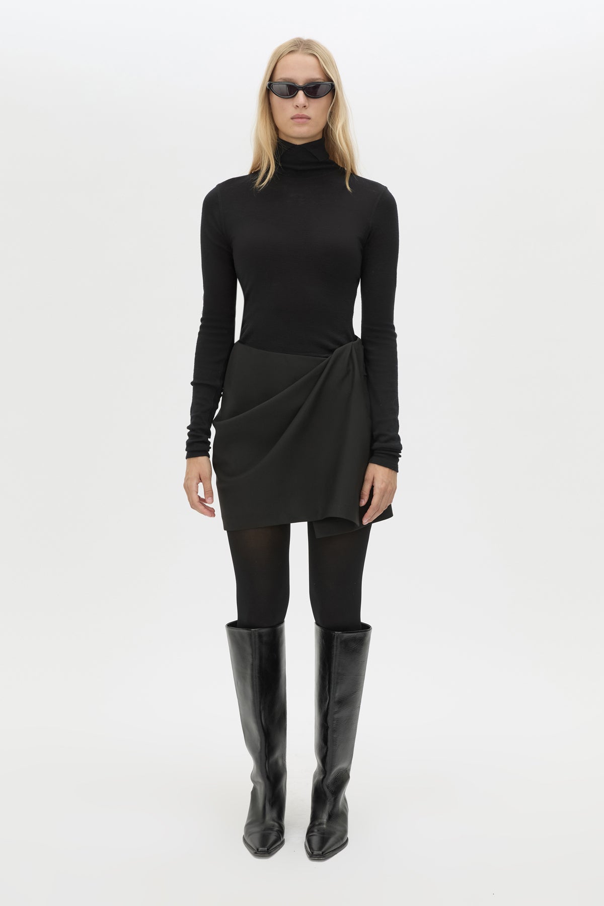 Front styled view CAMILLA AND MARC Mackinley Mini Wrap Skirt in Black with a draped low‑rise silhouette.