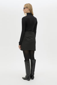 Back view CAMILLA AND MARC Mackinley Mini Wrap Skirt in Black with a draped low‑rise silhouette.