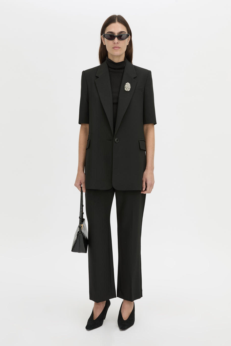 Front-styled view CAMILLA AND MARC Mackinley short sleeve blazer in black.