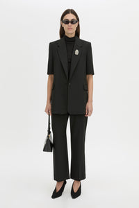 Front-styled view CAMILLA AND MARC Mackinley short sleeve blazer in black.