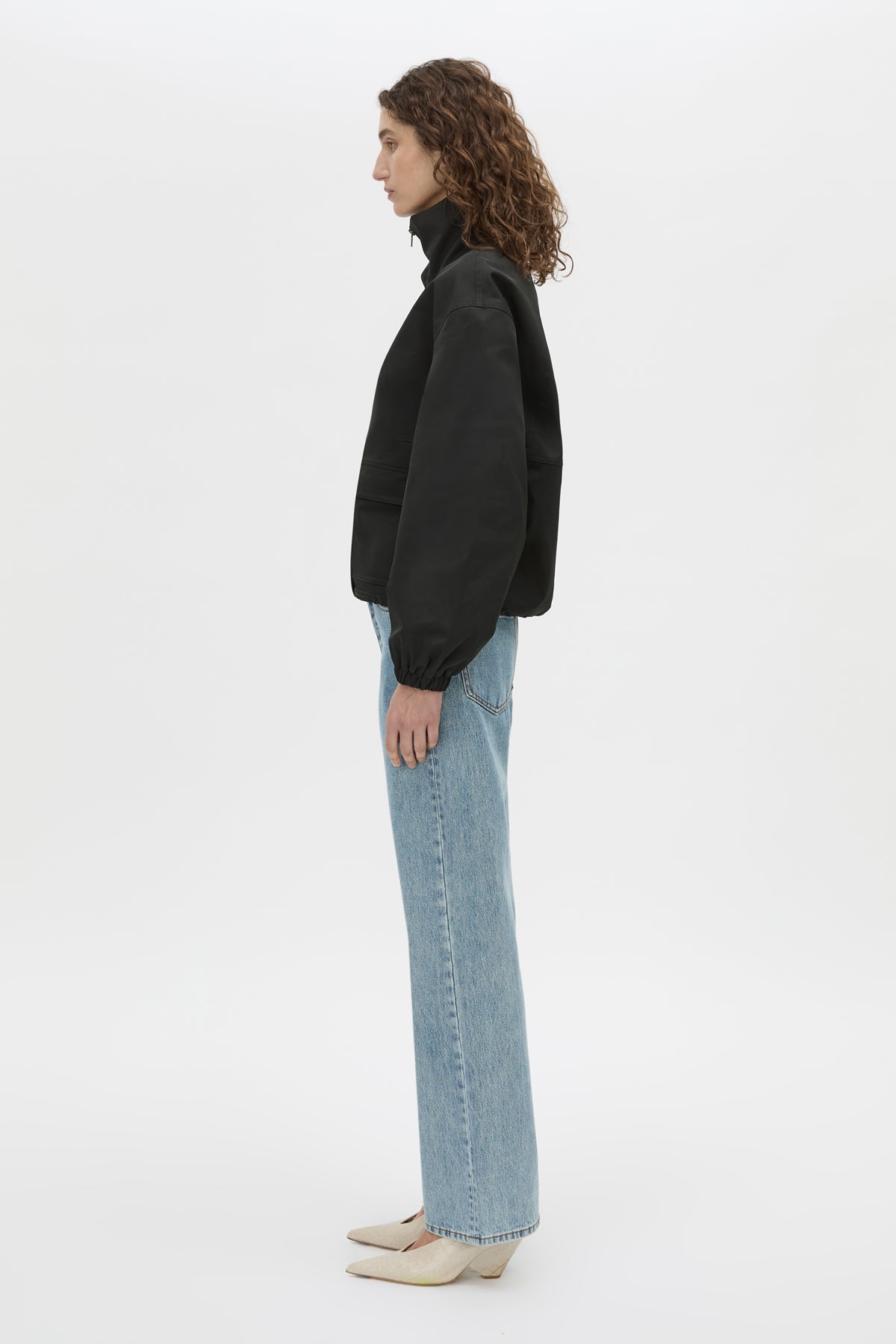 Side view CAMILLA AND MARC Mahdavi funnel neck jacket in black.