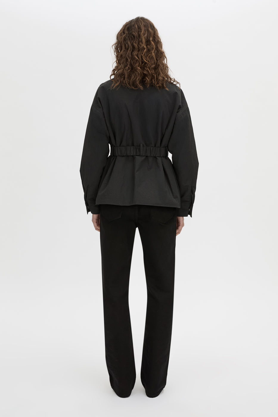 Back view CAMILLA AND MARC Manon Padded Belted Jacket in black with hammered textured fabrication.